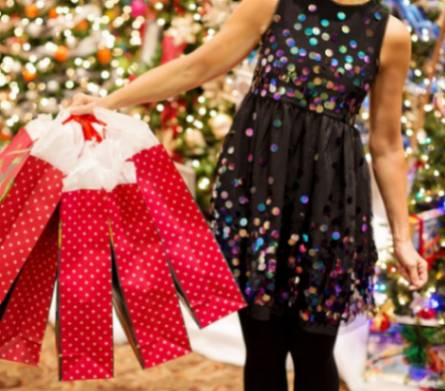 A holiday shopper with bags containing books by self-publishing authors